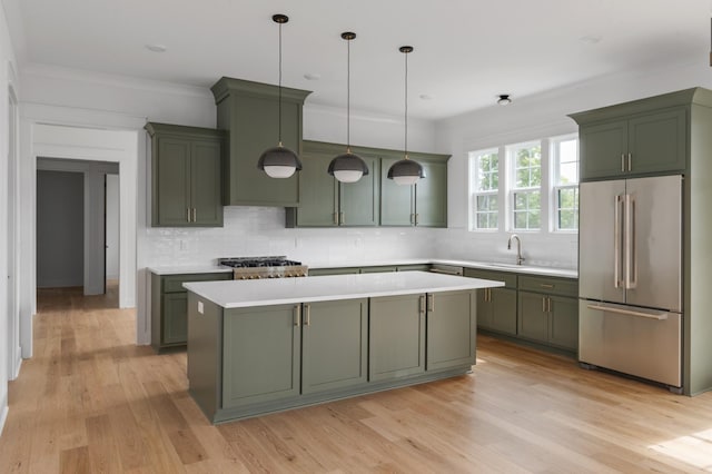 kitchen featuring high end fridge, light countertops, and green cabinetry