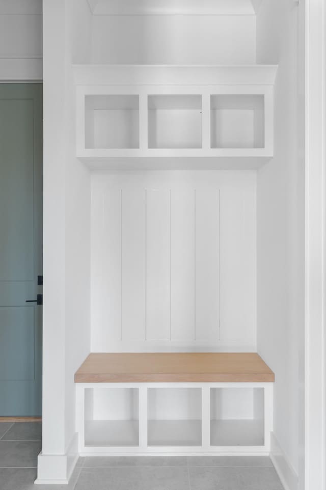 mudroom with tile patterned flooring and baseboards