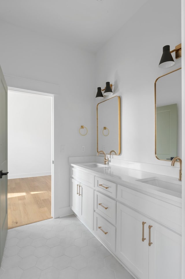 bathroom featuring double vanity, a sink, and tile patterned floors