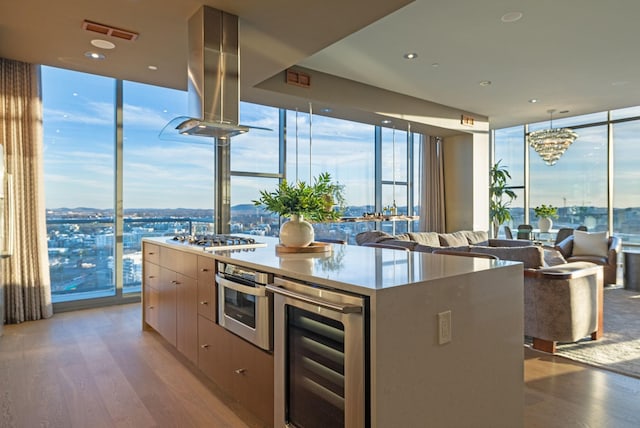 kitchen with expansive windows, modern cabinets, wine cooler, and appliances with stainless steel finishes