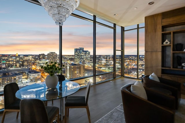 sunroom / solarium with a view of city and a notable chandelier