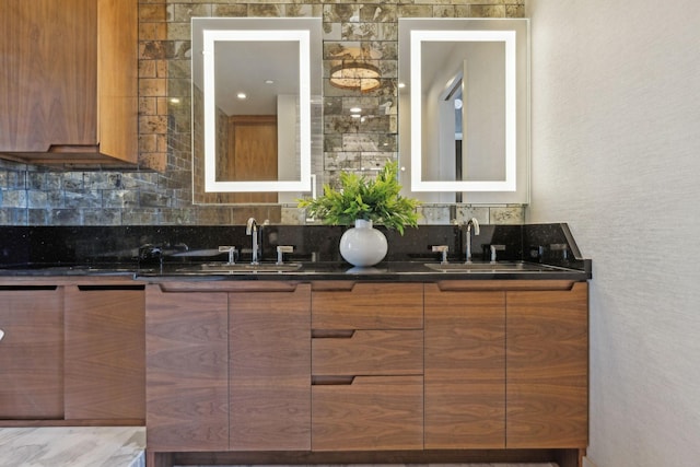 bathroom with a sink, backsplash, and double vanity