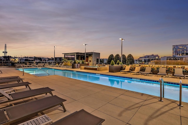 pool featuring a patio and a hot tub