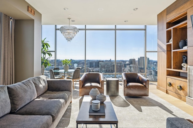 living room featuring floor to ceiling windows, a notable chandelier, a city view, and wood finished floors