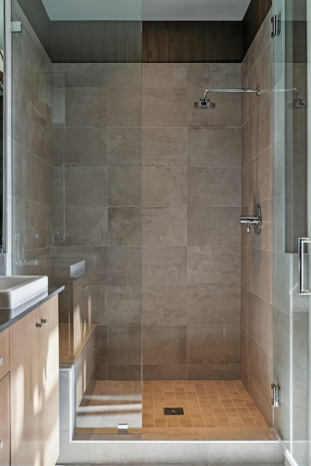 bathroom featuring a shower stall and vanity