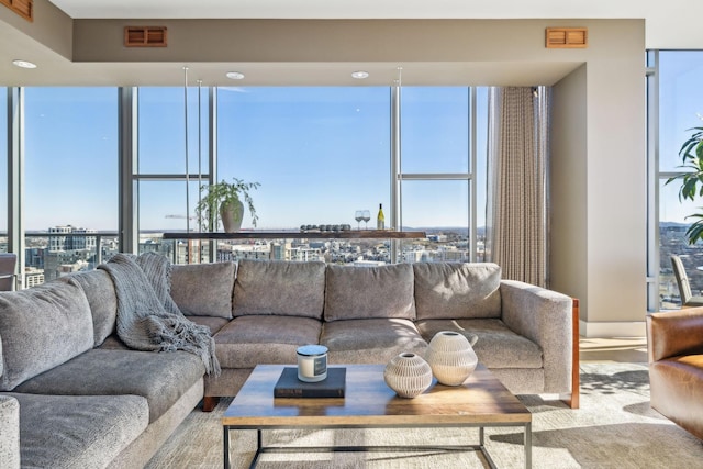 living area featuring a view of city, expansive windows, and visible vents