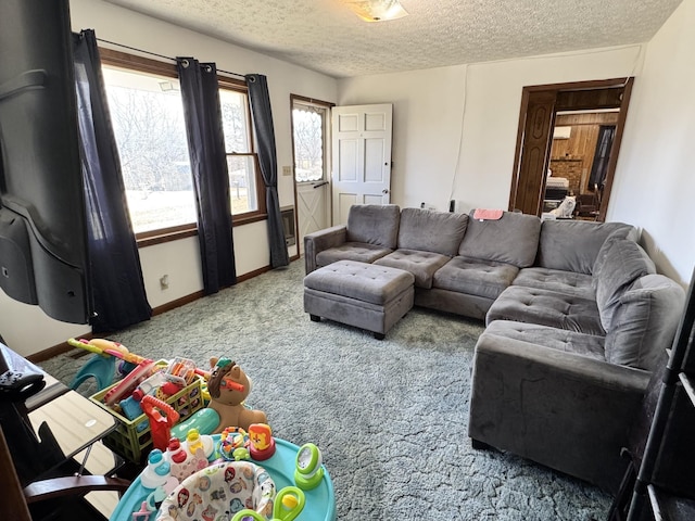 carpeted living area featuring baseboards and a textured ceiling