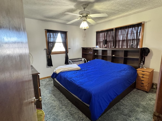 carpeted bedroom featuring ceiling fan, baseboards, and a textured ceiling