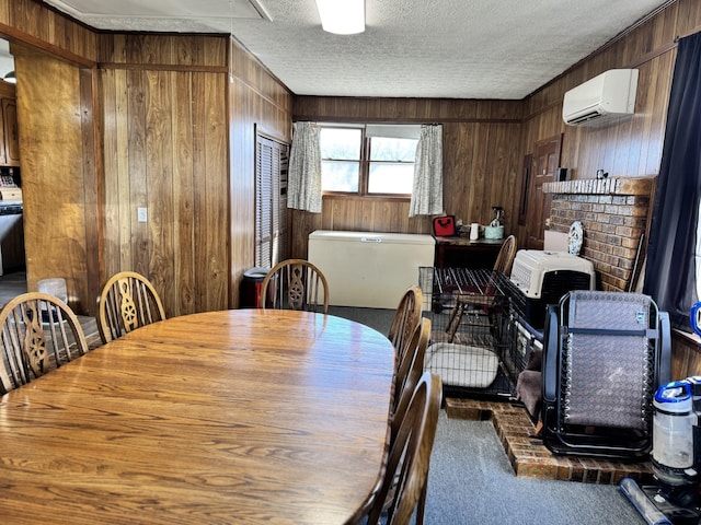 dining room featuring wood walls, carpet, a textured ceiling, and a wall mounted air conditioner