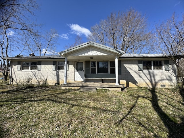 view of front of house featuring brick siding, crawl space, and a front yard