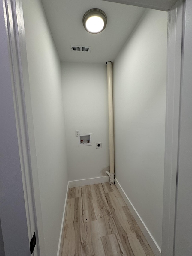 laundry area with hookup for a washing machine, light wood-style flooring, laundry area, visible vents, and electric dryer hookup