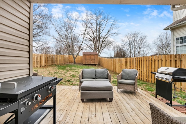 deck with a fenced backyard, an outdoor hangout area, and area for grilling