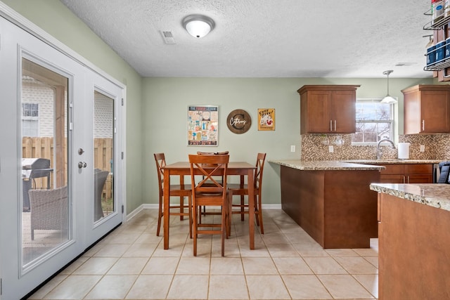 dining area with light tile patterned floors, visible vents, baseboards, and french doors