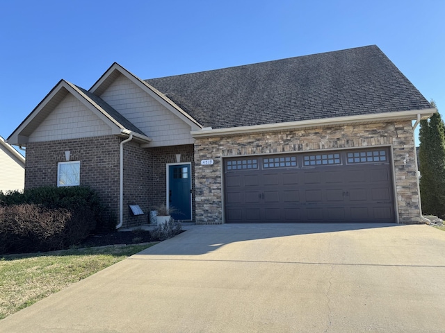 view of front of home with concrete driveway, an attached garage, brick siding, and roof with shingles