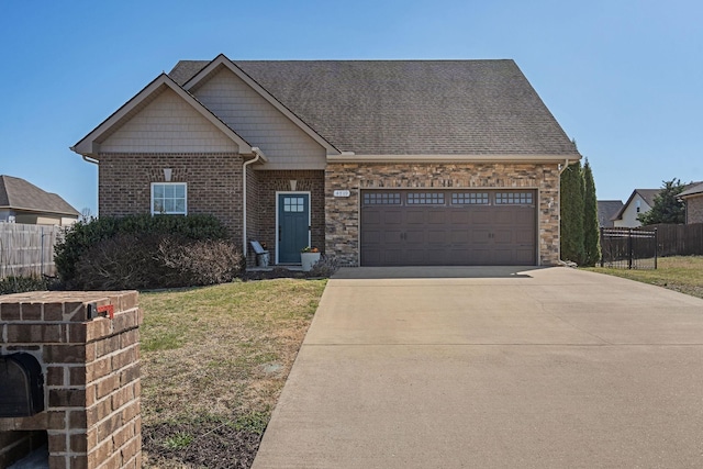 view of front of home with a front lawn, driveway, fence, an attached garage, and brick siding