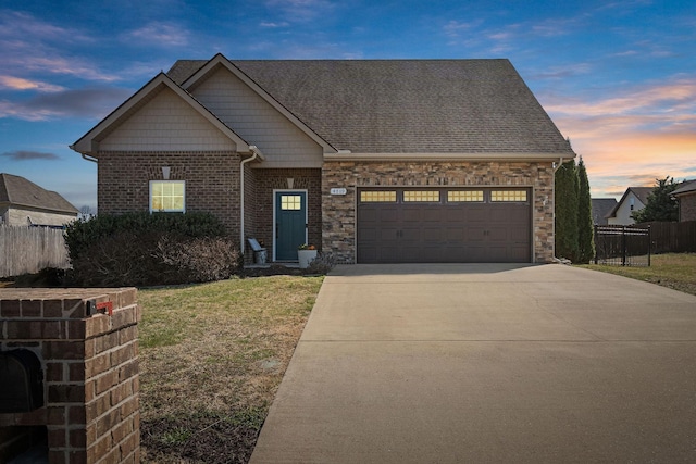 view of front of property with a yard, fence, a garage, and driveway