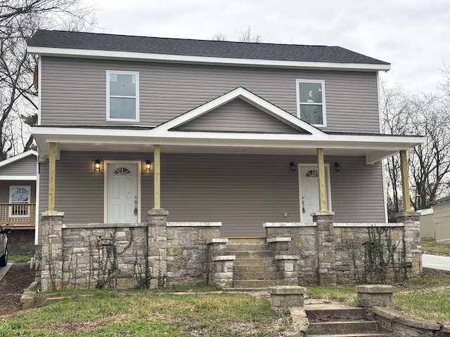 view of front of home featuring a porch and stone siding