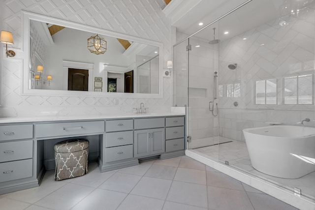 bathroom featuring tile walls, vaulted ceiling, a shower stall, and vanity