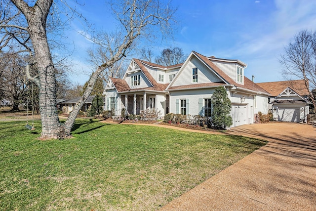 view of front of property with a garage, a front yard, and concrete driveway