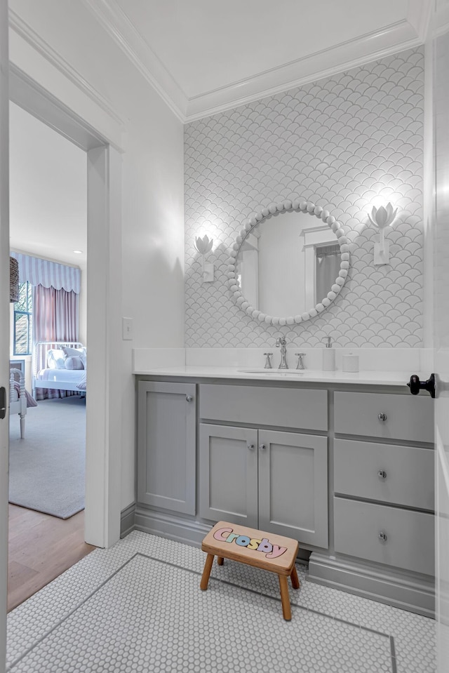 bathroom featuring ornamental molding, backsplash, and vanity