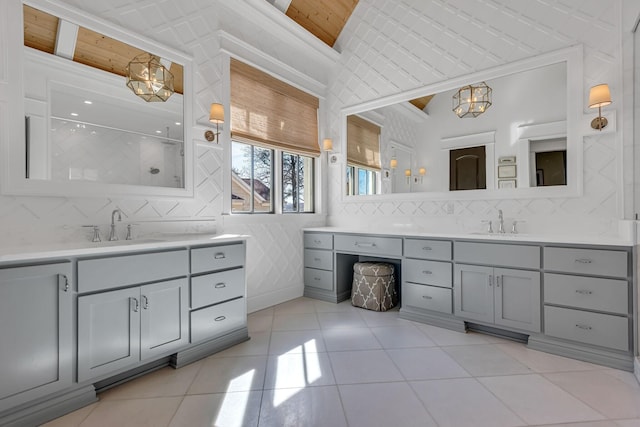 full bathroom featuring two vanities, a sink, and tile patterned floors