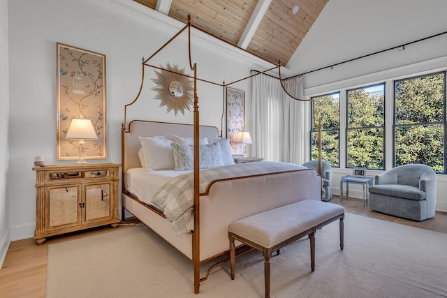 bedroom with high vaulted ceiling, beamed ceiling, light wood-type flooring, and wood ceiling