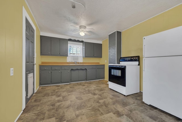 kitchen with a sink, range with electric cooktop, gray cabinets, and freestanding refrigerator