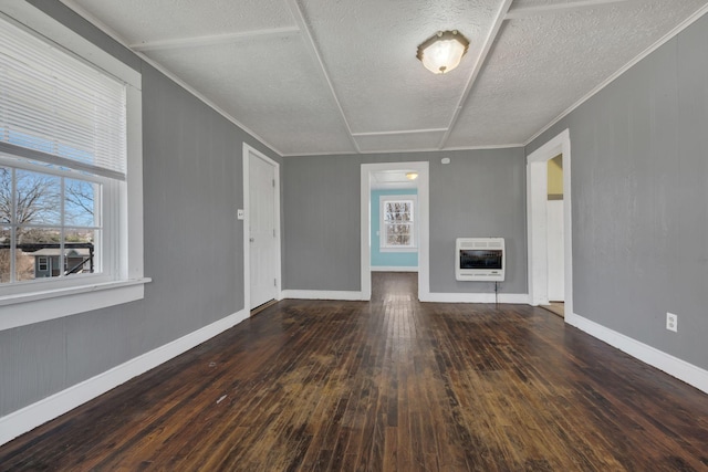 unfurnished living room featuring a fireplace, heating unit, ornamental molding, baseboards, and hardwood / wood-style flooring