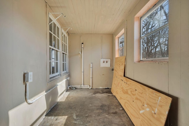 hall with concrete flooring and wooden ceiling