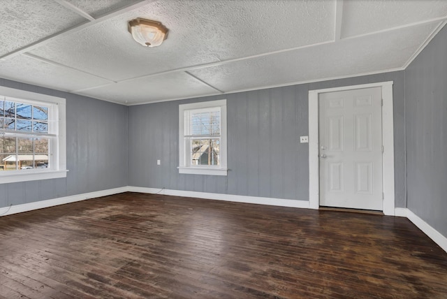 interior space with plenty of natural light, baseboards, and hardwood / wood-style flooring