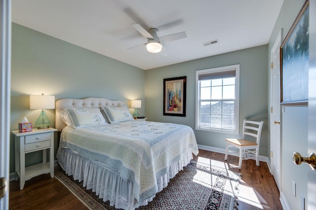 bedroom featuring a ceiling fan, baseboards, visible vents, and dark wood-style flooring