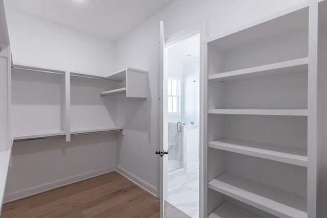 spacious closet with wood finished floors