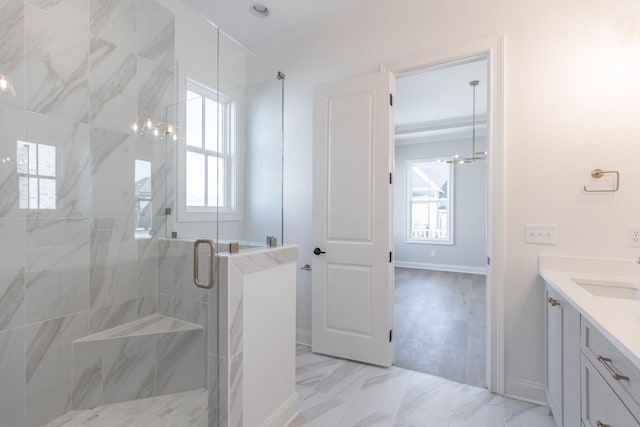 bathroom with marble finish floor, a shower stall, baseboards, and vanity