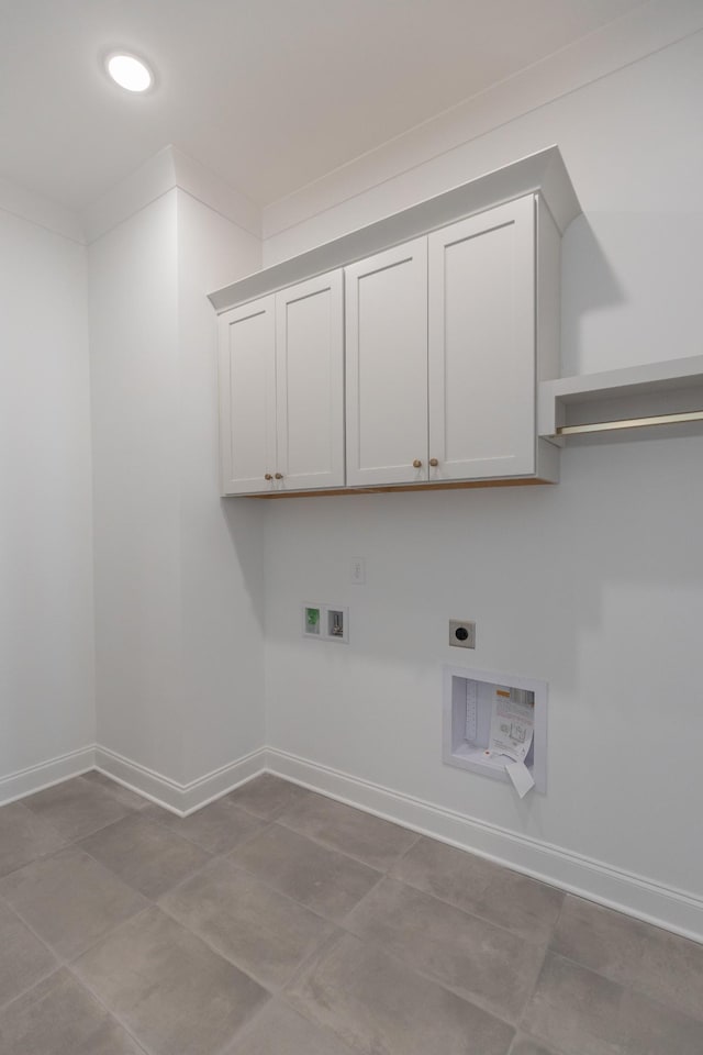 laundry area with cabinet space, baseboards, ornamental molding, hookup for a washing machine, and electric dryer hookup