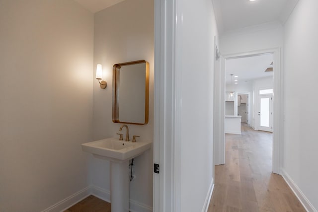 bathroom with wood finished floors and baseboards