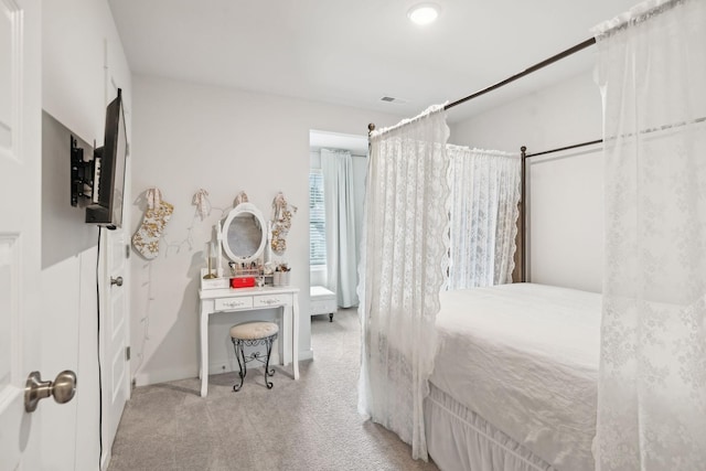 carpeted bedroom featuring visible vents