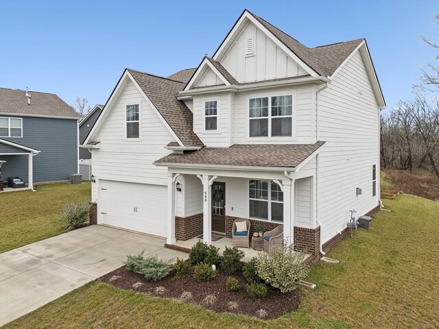 view of front of house featuring central AC unit, a front lawn, board and batten siding, and a shingled roof