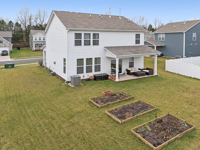 back of house with a garden, a lawn, fence, cooling unit, and an outdoor living space