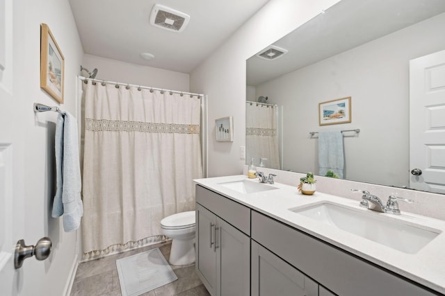 full bathroom featuring toilet, visible vents, and a sink