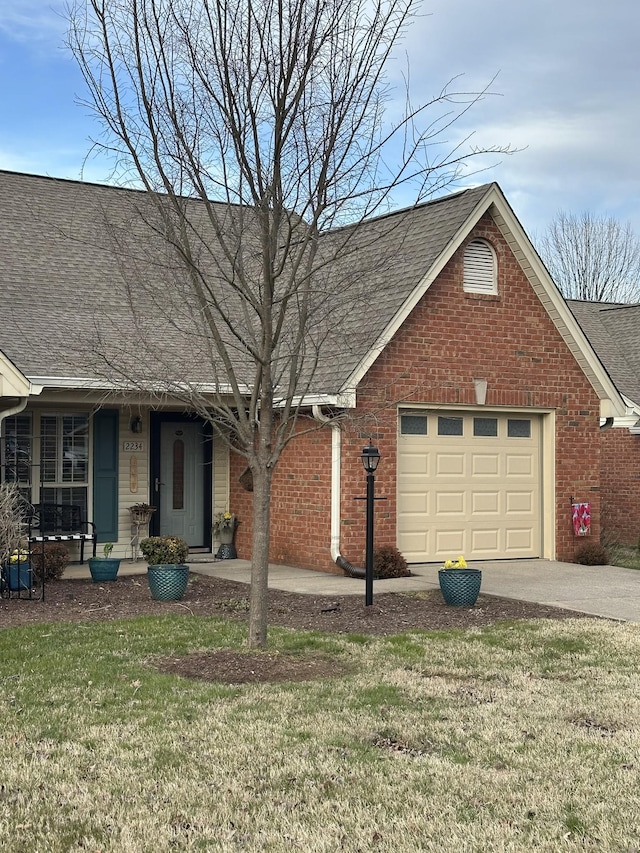 view of front facade featuring an attached garage, brick siding, a shingled roof, and a front yard