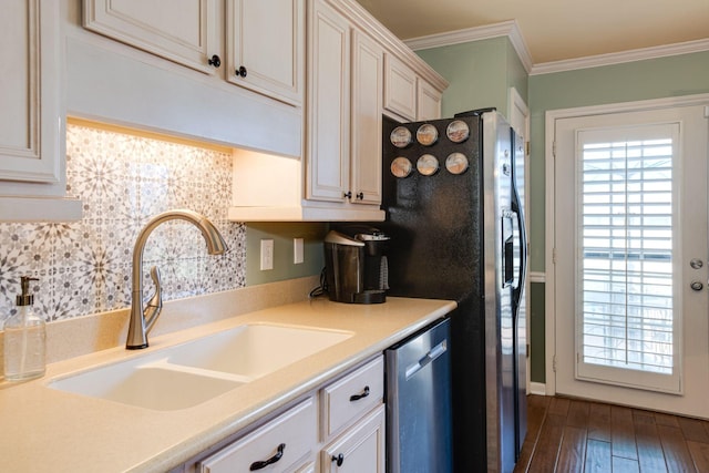 kitchen with a sink, plenty of natural light, stainless steel dishwasher, and ornamental molding