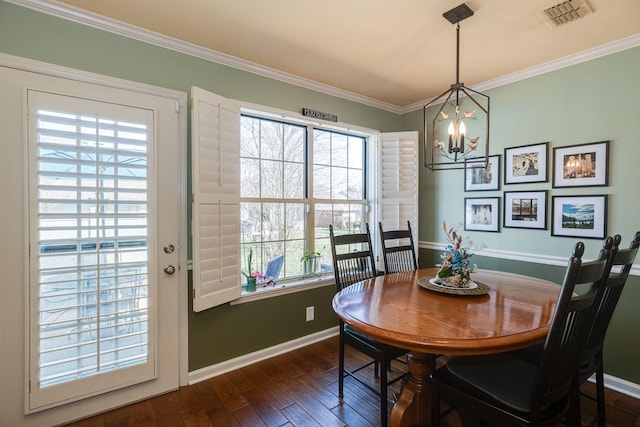 dining room with visible vents, baseboards, dark wood finished floors, and ornamental molding