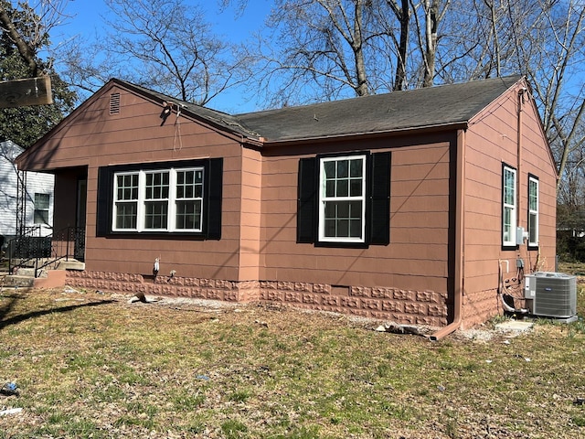 view of home's exterior featuring central AC and a lawn