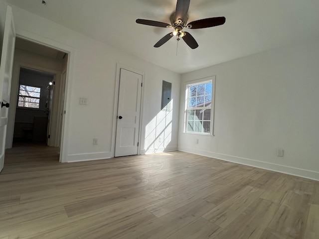 spare room with light wood-style flooring, baseboards, and ceiling fan