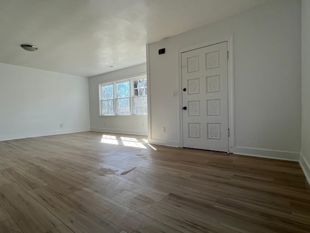 entrance foyer featuring wood finished floors and baseboards