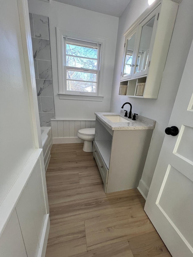 full bath with vanity, toilet, and wood finished floors