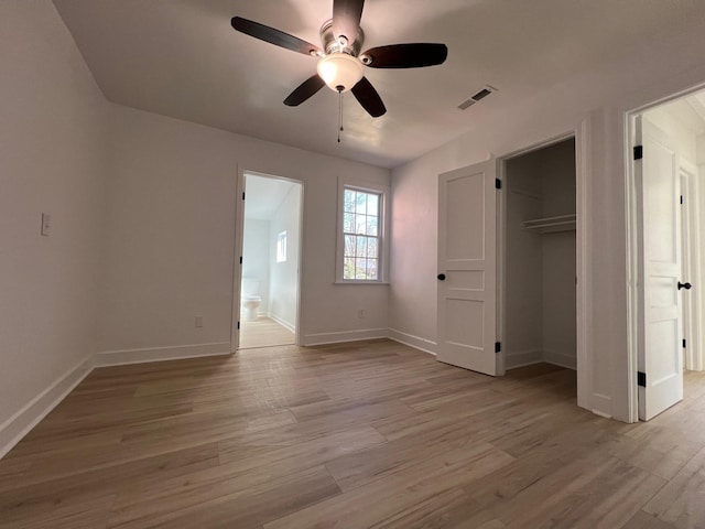 unfurnished bedroom featuring visible vents, connected bathroom, light wood-type flooring, and baseboards