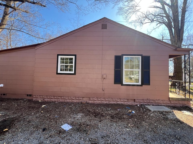 view of side of home featuring crawl space