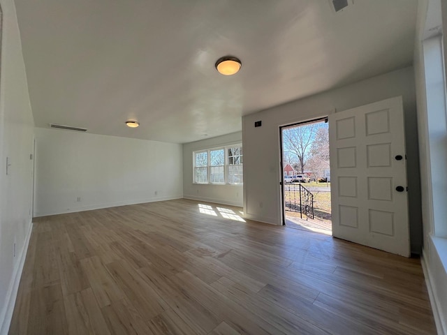 interior space featuring visible vents, baseboards, and wood finished floors