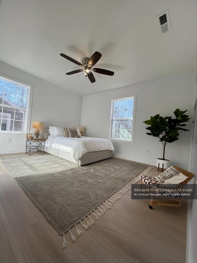 unfurnished bedroom with a ceiling fan, baseboards, and visible vents